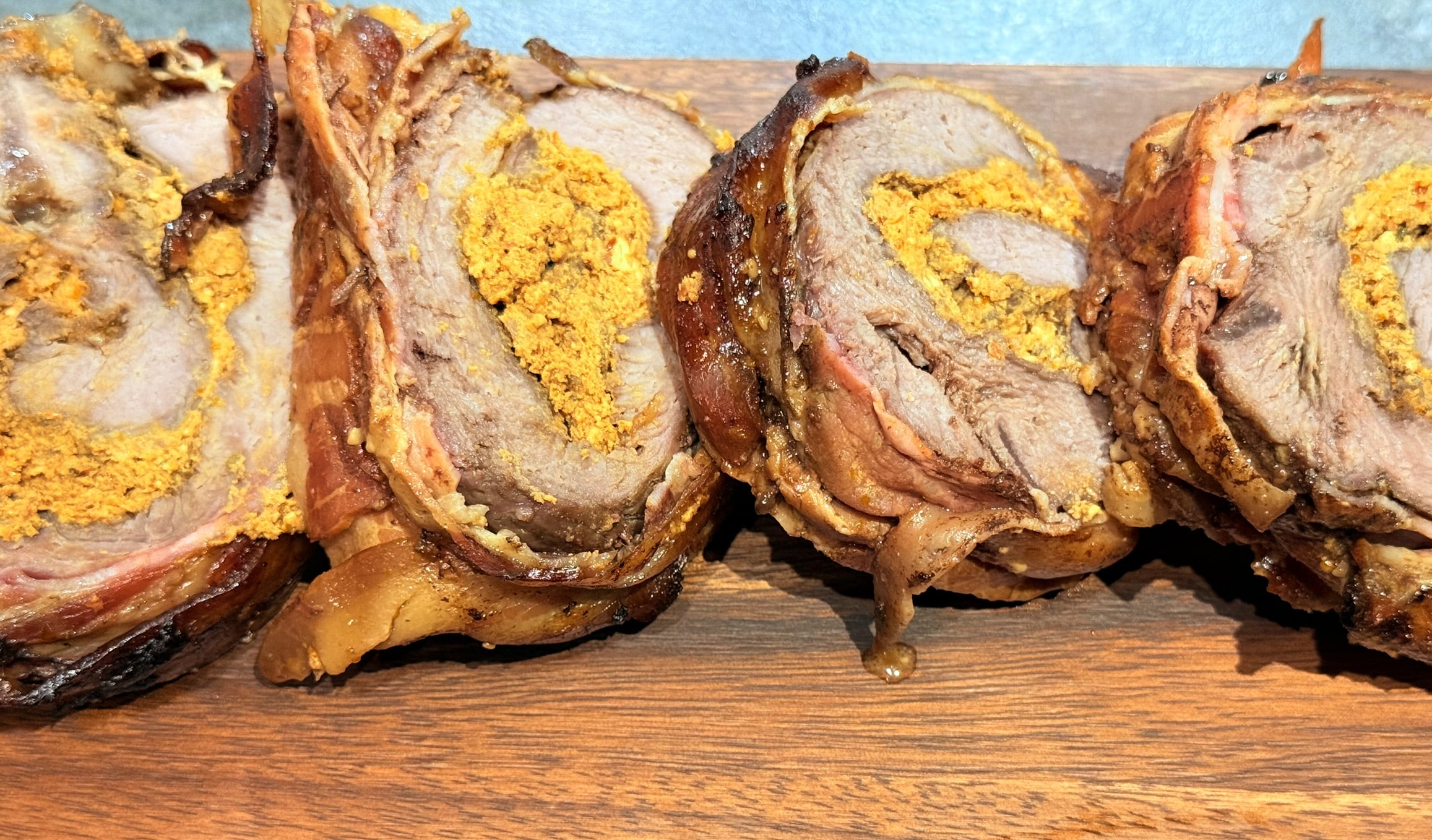 Mușchi de porc în bacon umplut cu feta și roșii uscate